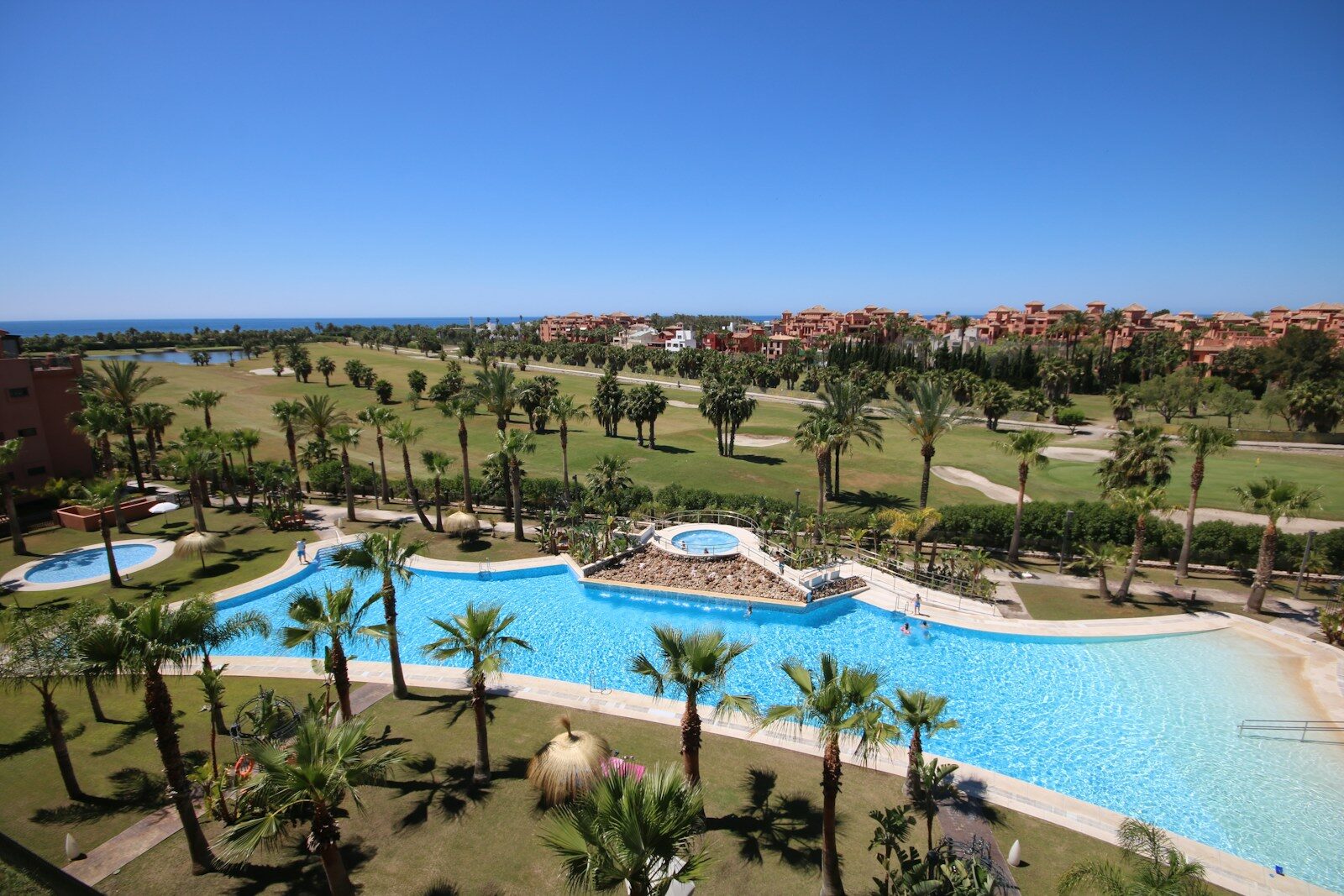 Resort pool with palm trees Andalusia